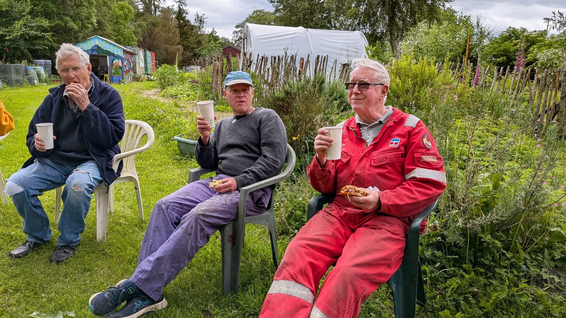 Three members enjoying tea and rolls at the allotment