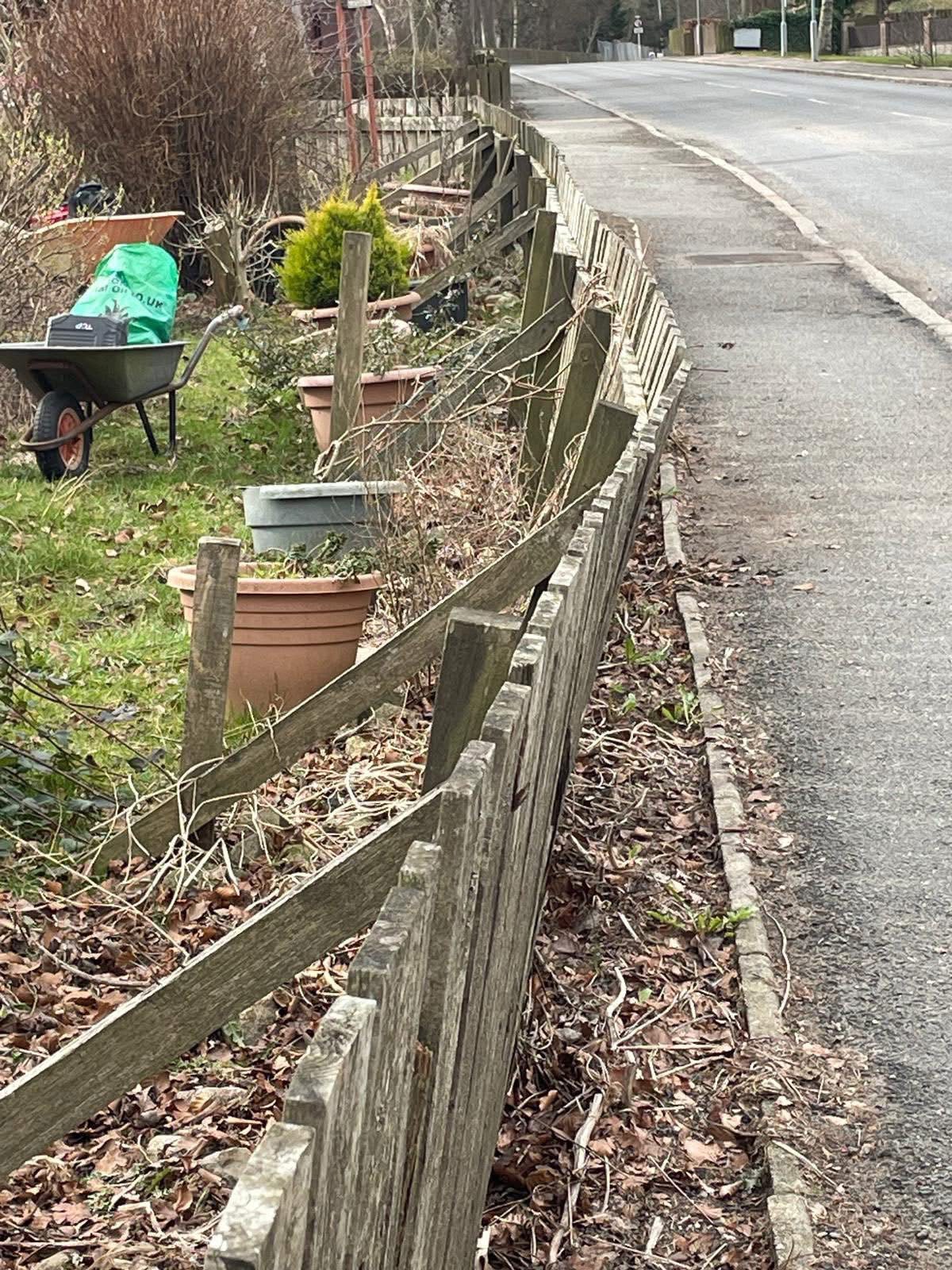 Weathered wooden fence at Birleybush garden before repair